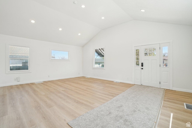 interior space with recessed lighting, visible vents, light wood-type flooring, and lofted ceiling