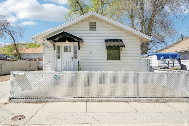 bungalow-style home featuring a fenced front yard