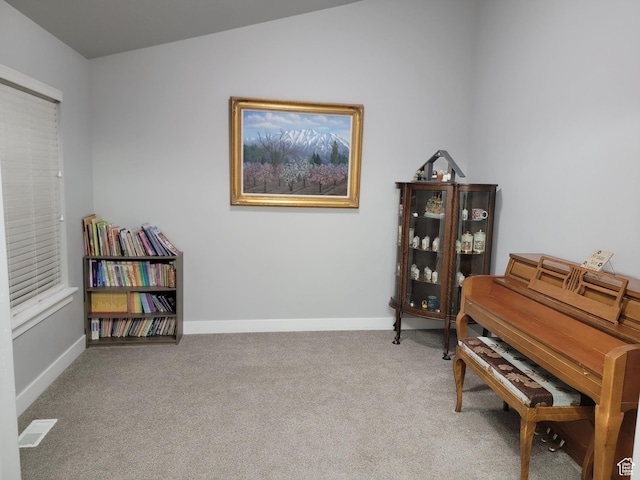 sitting room with visible vents, baseboards, and carpet flooring