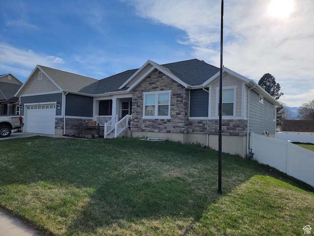 view of front of home featuring a shingled roof, stone siding, a garage, fence, and a front lawn