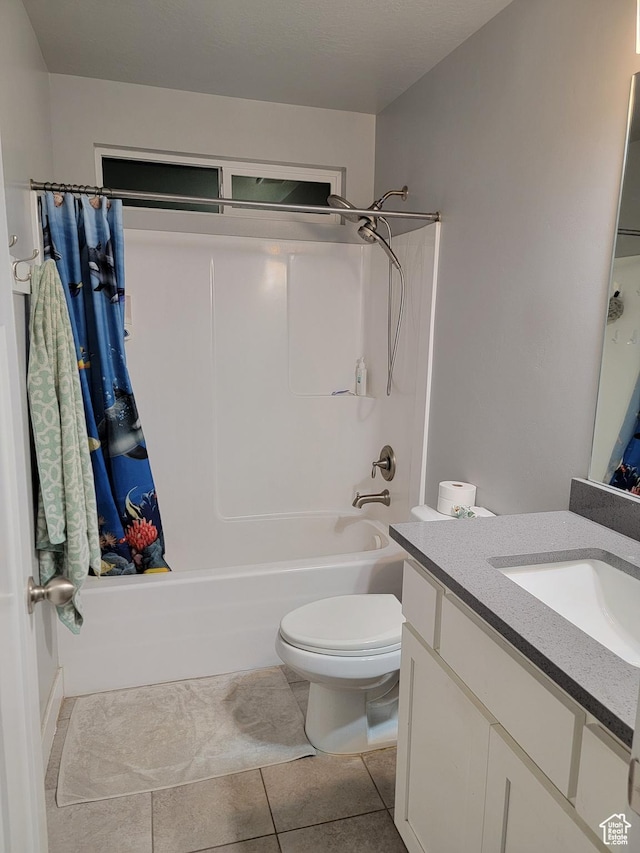 bathroom featuring tile patterned flooring, vanity, shower / bathing tub combination, and toilet