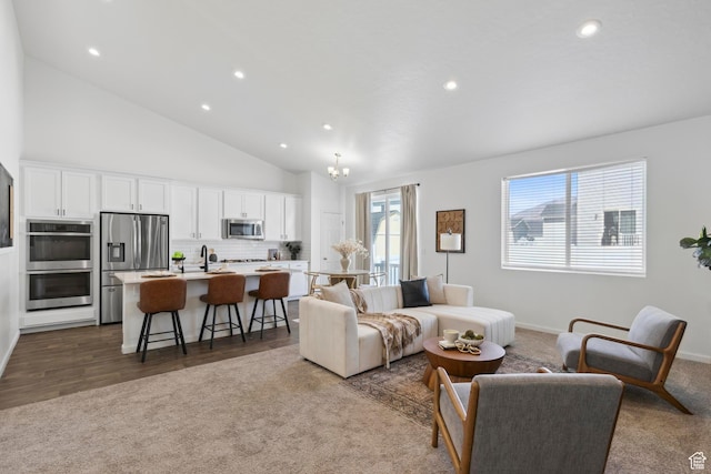 living room with dark colored carpet, a chandelier, recessed lighting, lofted ceiling, and baseboards