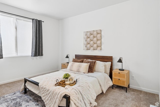 bedroom with baseboards and carpet floors