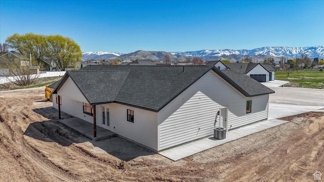 432 Tee Cir, Preston, ID 83263 - view of home's exterior with a mountain view, a patio, cooling unit, and a shingled roof