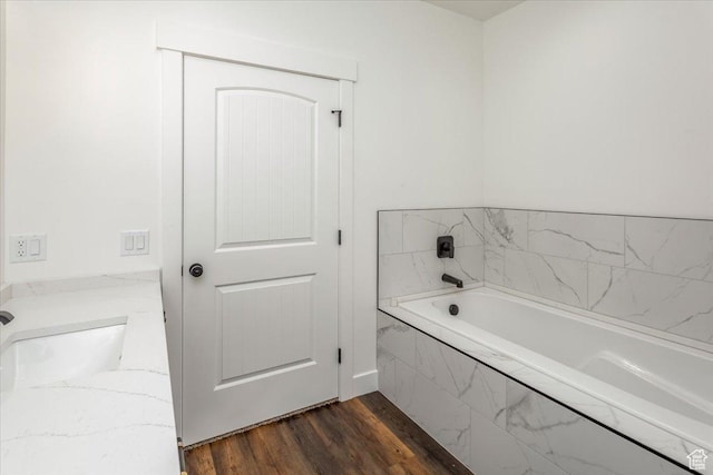 432 Tee Cir, Preston, ID 83263 - full bathroom featuring a garden tub, wood finished floors, and a sink