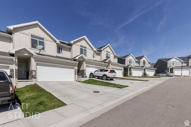 790 E Ruby Dr, Morgan, UT 84050 - view of front of home featuring driveway, stone siding, a residential view, and a garage