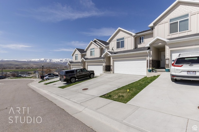 790 E Ruby Dr, Morgan, UT 84050 - view of front of property featuring a mountain view, driveway, stone siding, board and batten siding, and an attached garage