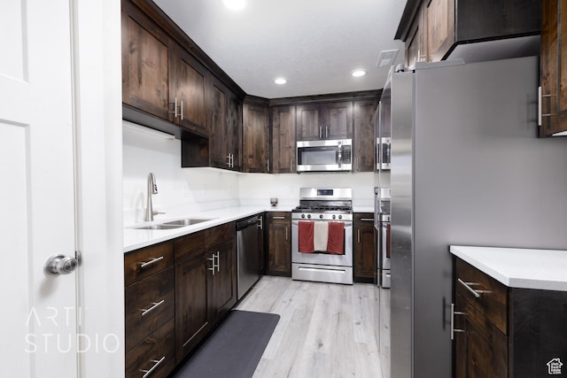 790 E Ruby Dr, Morgan, UT 84050 - kitchen featuring a sink, dark brown cabinets, light wood finished floors, recessed lighting, and stainless steel appliances