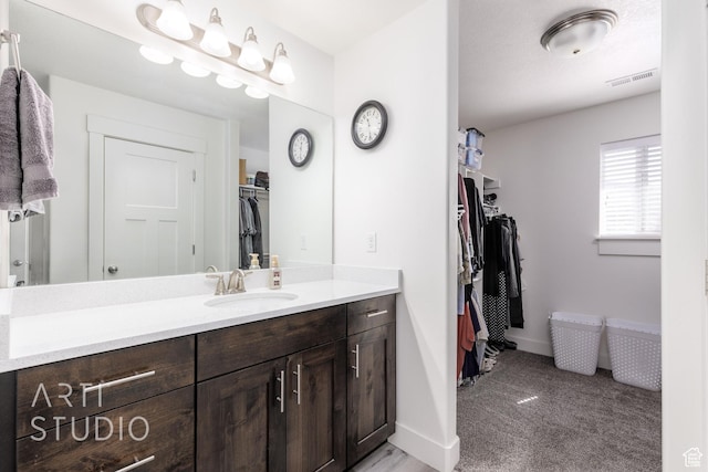 790 E Ruby Dr, Morgan, UT 84050 - full bathroom with a spacious closet, vanity, visible vents, and baseboards