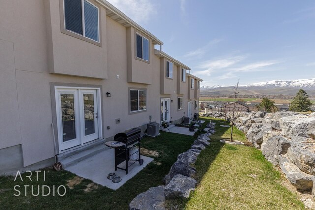 790 E Ruby Dr, Morgan, UT 84050 - rear view of house with a mountain view, entry steps, a lawn, central air condition unit, and stucco siding