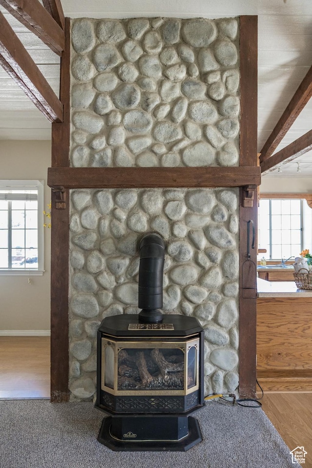 1370 S 1900 E, Vernal, UT 84078 - room details featuring wood finished floors, beamed ceiling, baseboards, and a wood stove