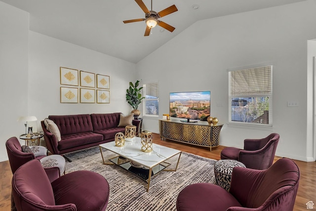 living room with high vaulted ceiling, a ceiling fan, wood finished floors, and baseboards
