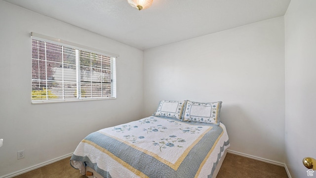 carpeted bedroom featuring baseboards