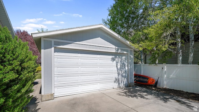 detached garage featuring fence
