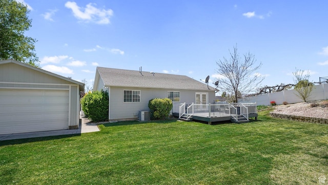rear view of property with central AC unit, fence, a wooden deck, and a lawn