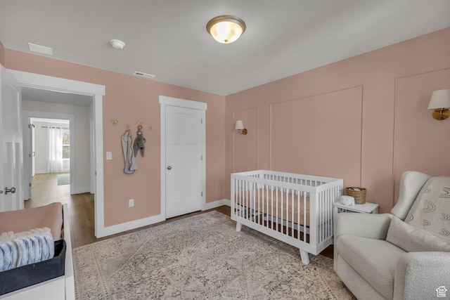 1958 E Janet Kay Ln, Holladay, UT 84121 - bedroom with visible vents, baseboards, and wood finished floors