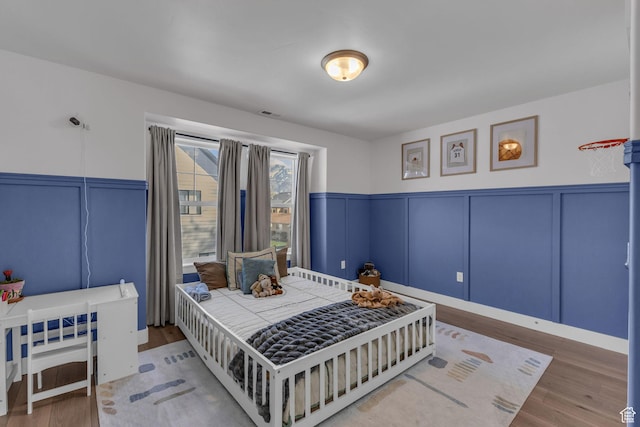 1958 E Janet Kay Ln, Holladay, UT 84121 - bedroom featuring a decorative wall, wood finished floors, and a wainscoted wall