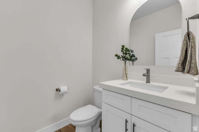 1958 E Janet Kay Ln, Holladay, UT 84121 - half bathroom with toilet, wood finished floors, vanity, and baseboards