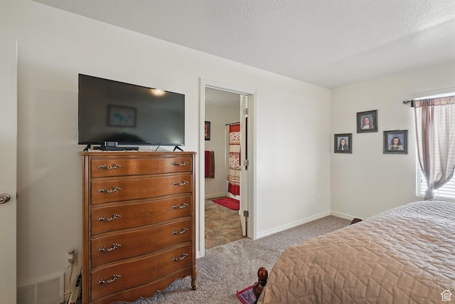 bedroom featuring visible vents, baseboards, and carpet