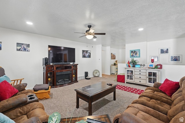 living area with baseboards, a ceiling fan, a textured ceiling, carpet floors, and recessed lighting