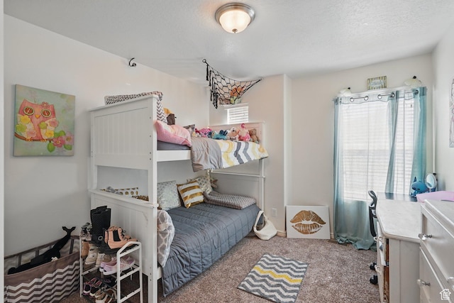 carpeted bedroom featuring a textured ceiling and multiple windows