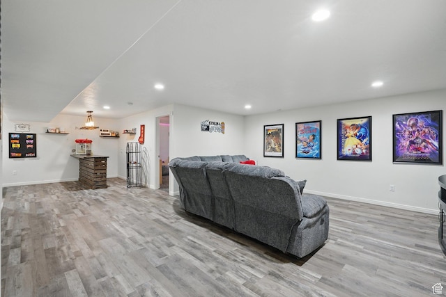 living area featuring wood finished floors, baseboards, and recessed lighting