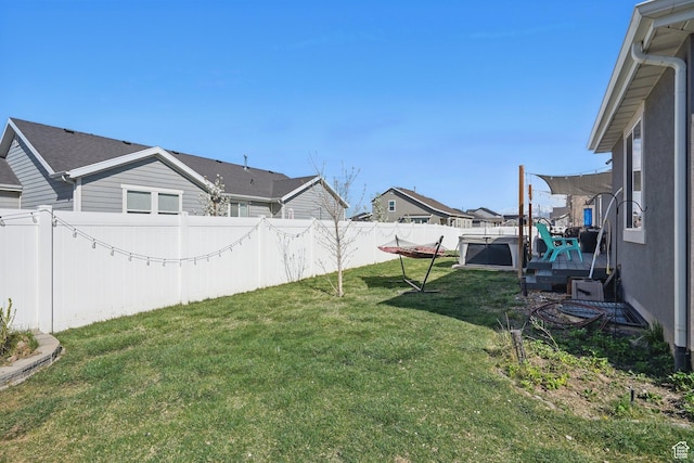 view of yard featuring a residential view and a fenced backyard