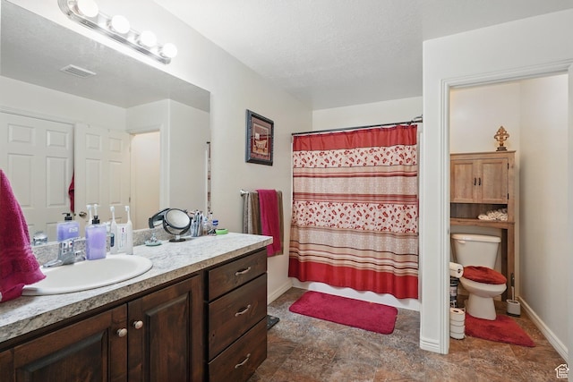 full bathroom with visible vents, baseboards, toilet, stone finish floor, and vanity