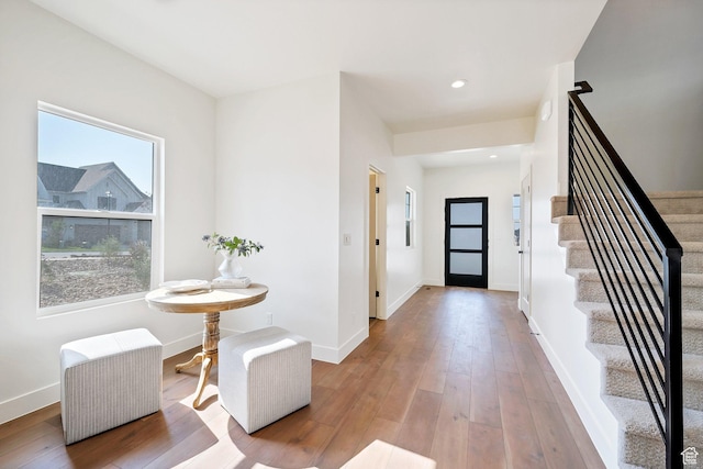 entrance foyer with hardwood / wood-style flooring, baseboards, and stairway