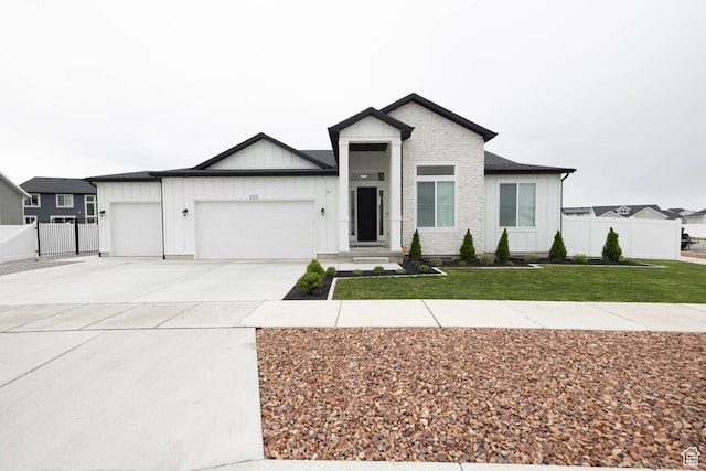293 N Pheasant Dr, Mapleton, UT 84664 - view of front of property featuring concrete driveway, board and batten siding, a front lawn, an attached garage, and fence