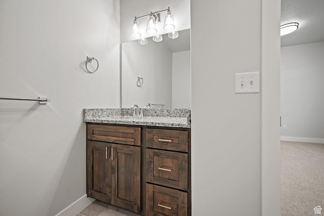 bathroom featuring vanity and baseboards