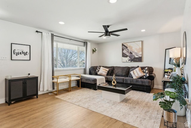 living room with recessed lighting, light wood finished floors, and a ceiling fan