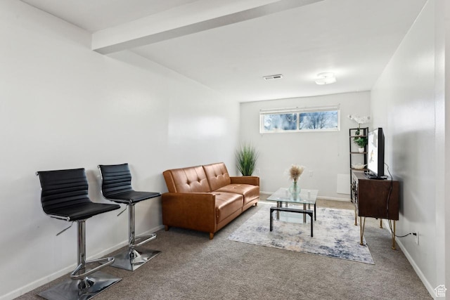 carpeted living area with visible vents and baseboards