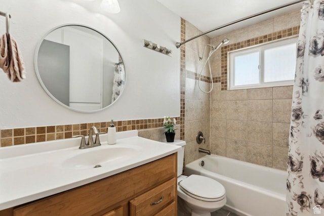 full bath featuring shower / tub combo with curtain, vanity, tile walls, and toilet