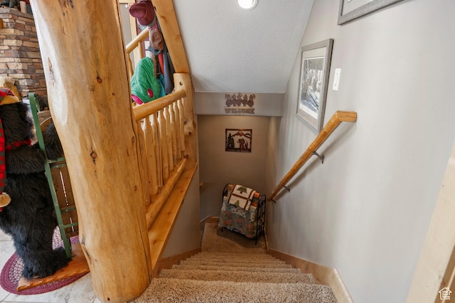 679 N Cambry Dr, Garden City, UT 84028 - stairway with a textured ceiling, baseboards, and lofted ceiling