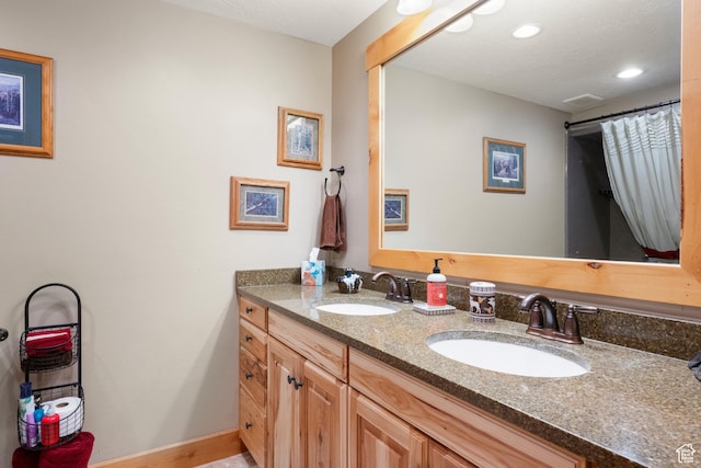 679 N Cambry Dr, Garden City, UT 84028 - bathroom with double vanity, baseboards, and recessed lighting