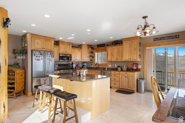 679 N Cambry Dr, Garden City, UT 84028 - kitchen featuring appliances with stainless steel finishes, light tile patterned flooring, a breakfast bar, recessed lighting, and a chandelier