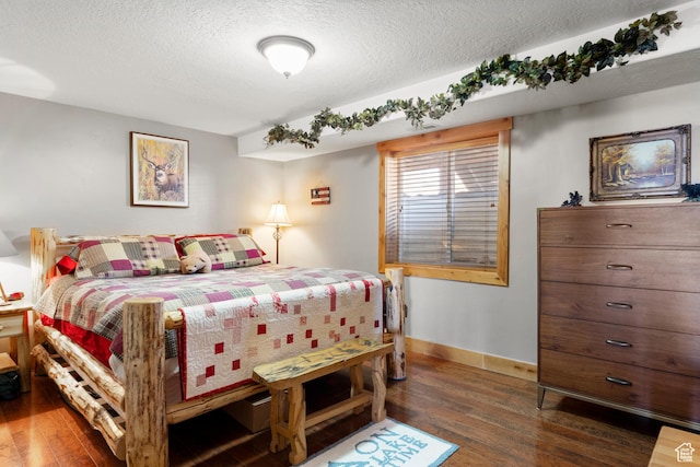 679 N Cambry Dr, Garden City, UT 84028 - bedroom with wood finished floors, a textured ceiling, and baseboards