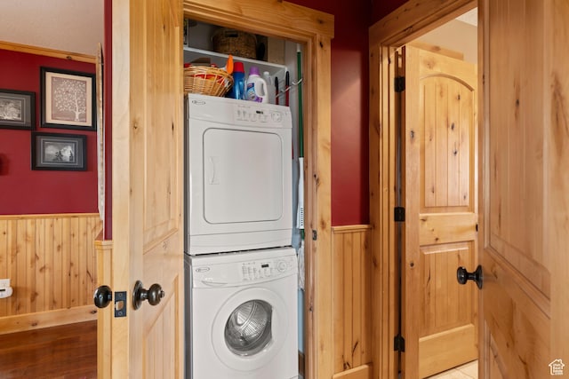 679 N Cambry Dr, Garden City, UT 84028 - washroom featuring stacked washer / drying machine, wainscoting, and wooden walls