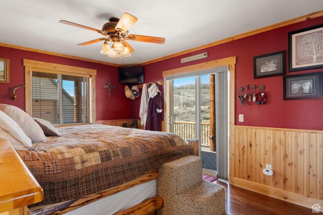 679 N Cambry Dr, Garden City, UT 84028 - bedroom with multiple windows, access to outside, wainscoting, wood finished floors, and ornamental molding