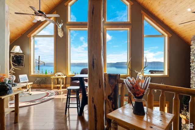 679 N Cambry Dr, Garden City, UT 84028 - dining area featuring wood ceiling, lofted ceiling, hardwood / wood-style floors, a water view, and plenty of natural light