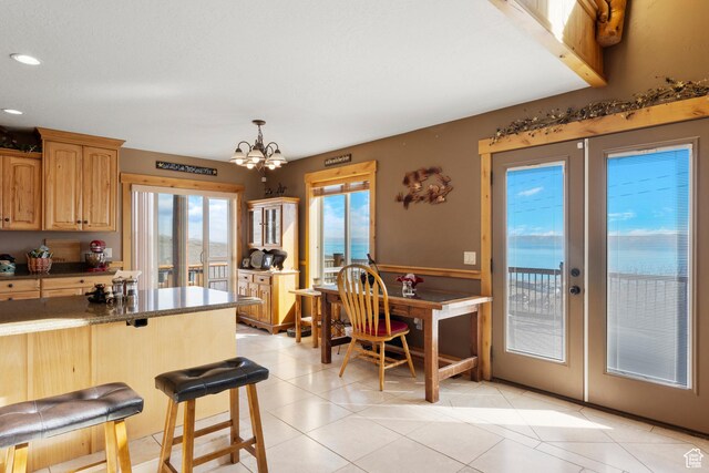 679 N Cambry Dr, Garden City, UT 84028 - kitchen featuring french doors, a chandelier, a breakfast bar, light tile patterned flooring, and recessed lighting