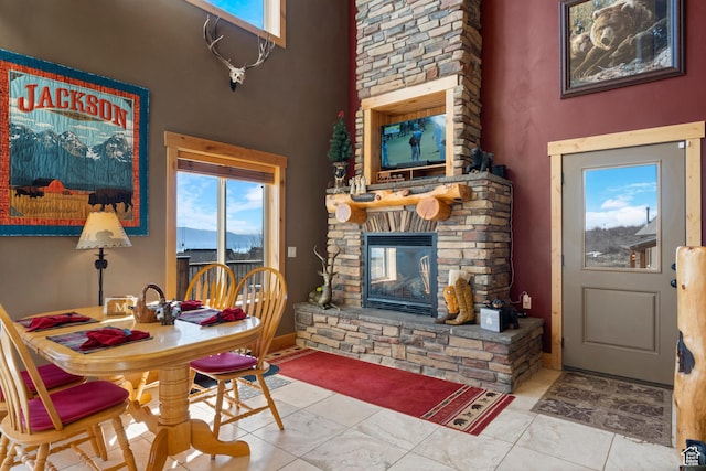 679 N Cambry Dr, Garden City, UT 84028 - dining space with a high ceiling, a stone fireplace, and healthy amount of natural light