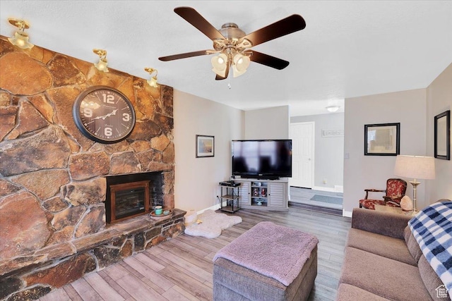 1480 N 1525 E, Logan, UT 84341 - living room with a fireplace, ceiling fan, baseboards, and wood finished floors
