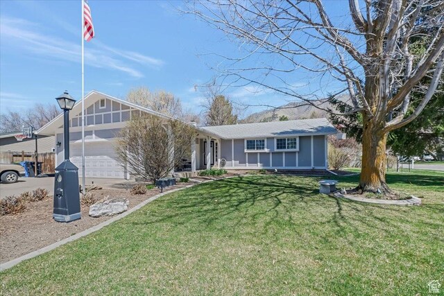 1480 N 1525 E, Logan, UT 84341 - view of front of house featuring an attached garage and a front lawn
