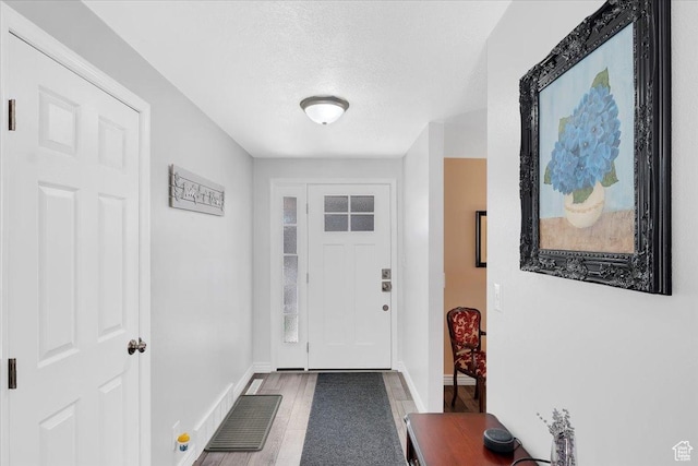 1480 N 1525 E, Logan, UT 84341 - doorway featuring visible vents, baseboards, wood finished floors, and a textured ceiling