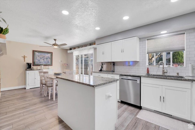 1480 N 1525 E, Logan, UT 84341 - kitchen featuring stainless steel dishwasher, a textured ceiling, a ceiling fan, a kitchen island, and a sink