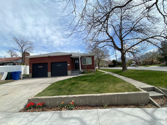 view of front of house with a front lawn, driveway, an attached garage, fence, and brick siding