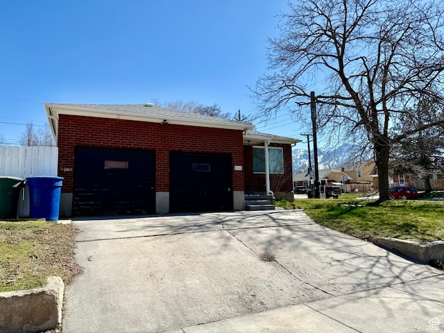 view of side of property with driveway and brick siding