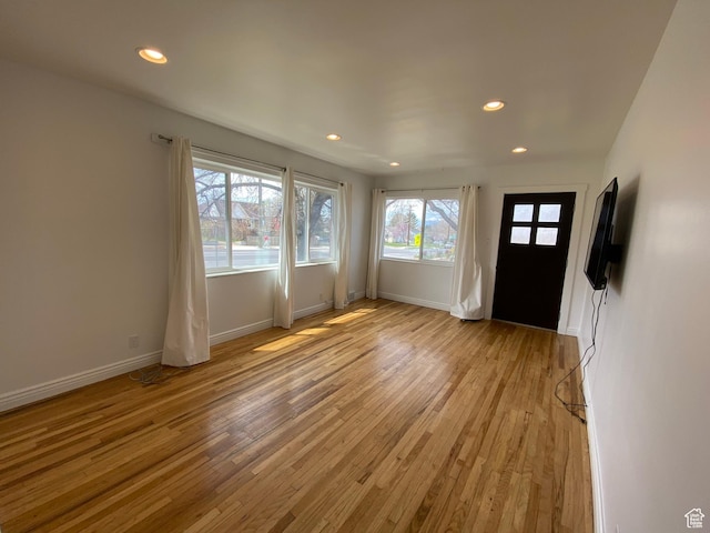 foyer featuring recessed lighting, light wood-type flooring, and baseboards